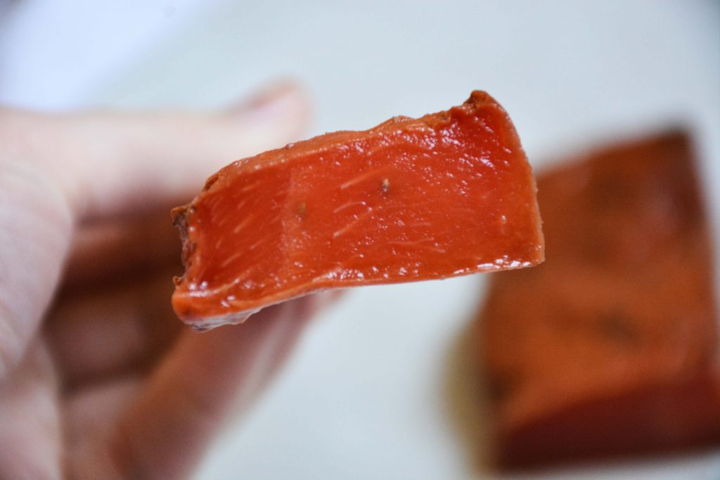 A slice of watermelon on a fork, baked in the oven to look and taste like fish.