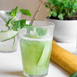 aloe vere cucumber cooler in glass with mint sprig and aloe vera leaf