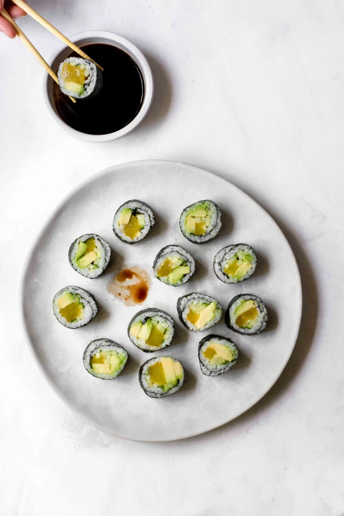 Maki sushi rolls with vegan fish, avocado, and cucumber