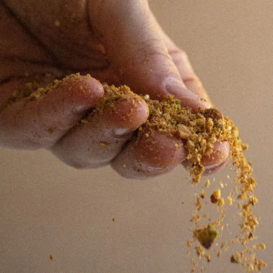Sprinkling dukkah from a hand